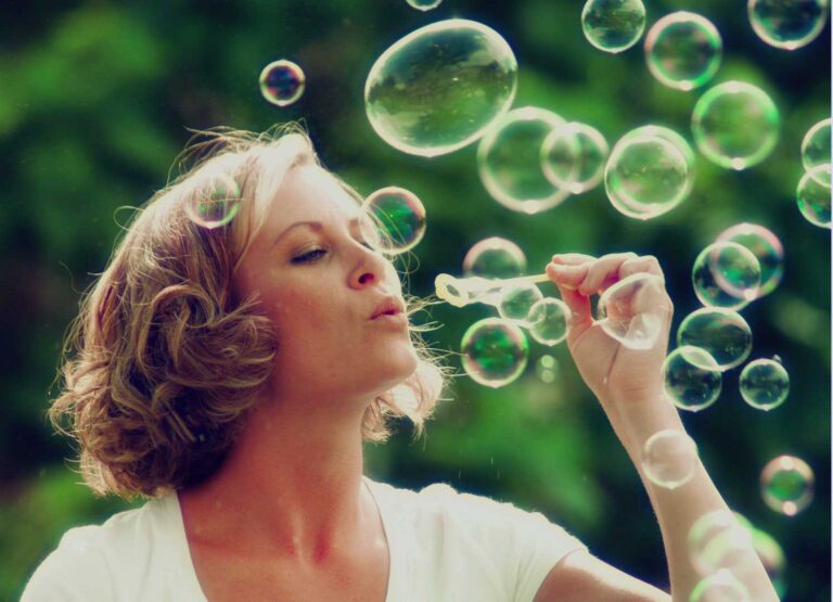 woman blowing bubbles