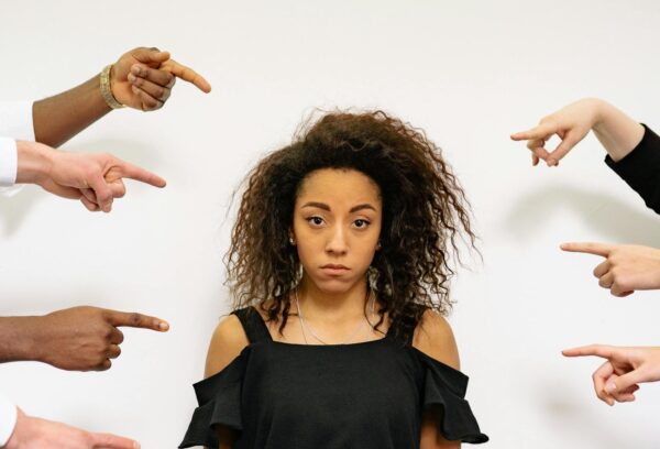 People Pointing Fingers at a Stressed Woman