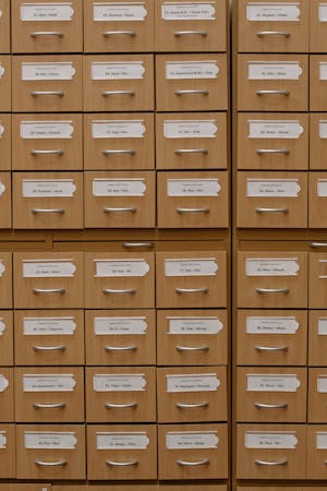 Vertical shot of labeled wooden file drawers for efficient organization