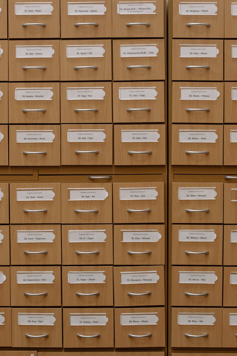 Vertical shot of labeled wooden file drawers for efficient organization