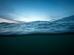 Capture of calm ocean waves during sunset in La Pampa, Argentina. Tranquil seascape with vivid sky.