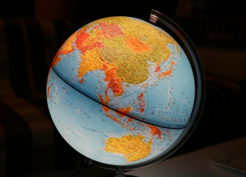A vibrant illuminated globe showcasing Earth's continents in a dark setting, ideal for educational and decor purposes.