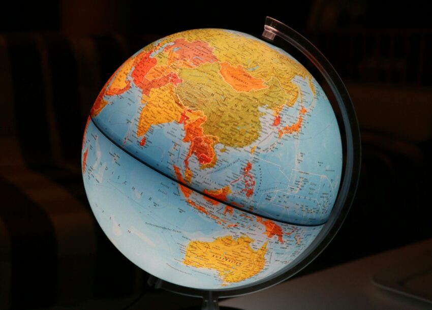 A vibrant illuminated globe showcasing Earth's continents in a dark setting, ideal for educational and decor purposes.
